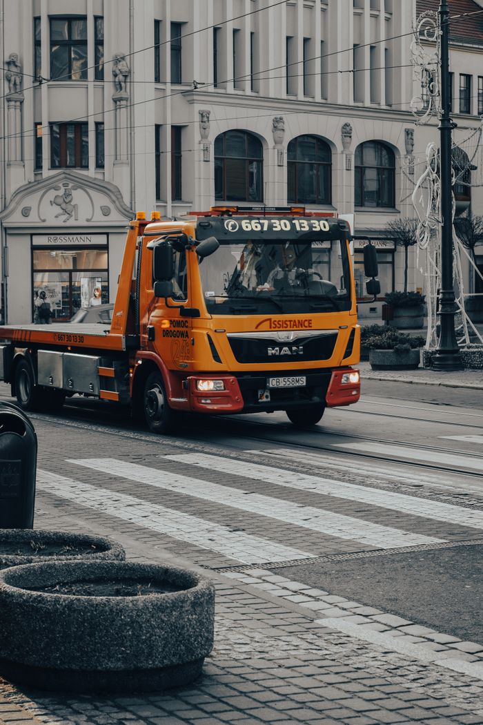 gallery-1 Tow truck driving on a pedestrian lane in downtown Bydgoszcz, Poland.